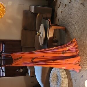 Rarely used dress. Beautiful bold orange color with floral.